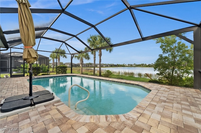 view of swimming pool with a lanai, a water view, and a patio area