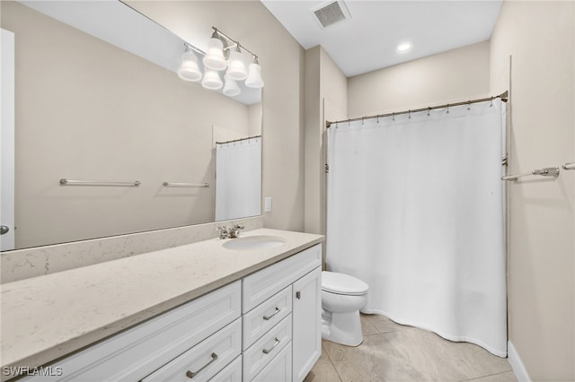 bathroom with tile patterned flooring, vanity, and toilet