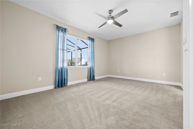 unfurnished room featuring light colored carpet and ceiling fan