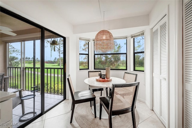 sunroom / solarium with plenty of natural light and ceiling fan