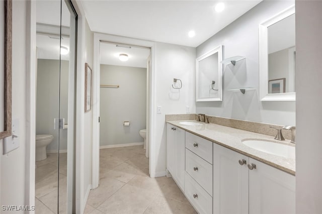 bathroom featuring tile patterned flooring, vanity, and toilet