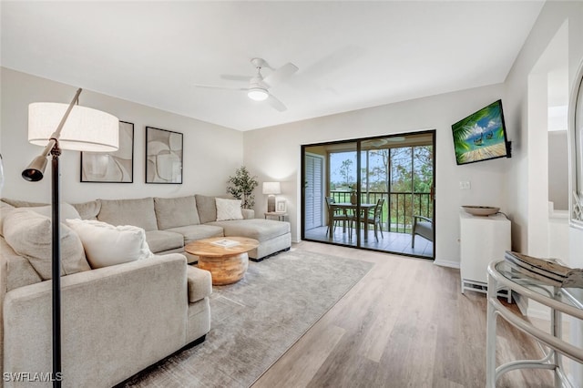 living room with hardwood / wood-style floors and ceiling fan