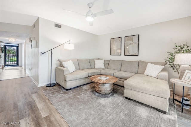 living room featuring ceiling fan and light hardwood / wood-style floors