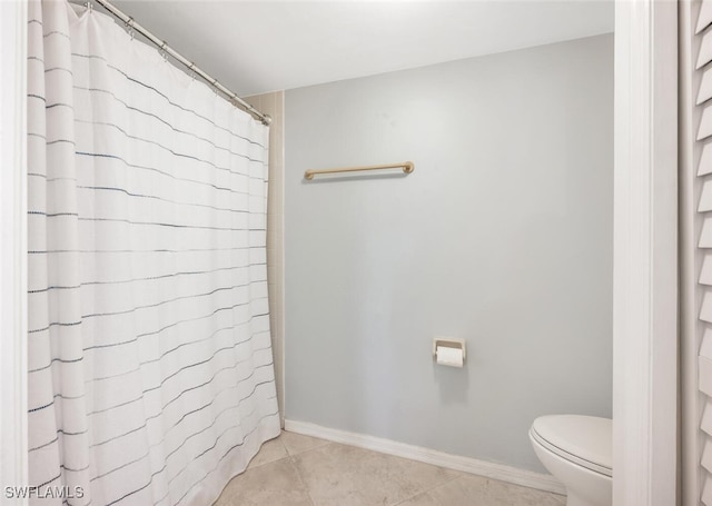 bathroom with tile patterned flooring and toilet