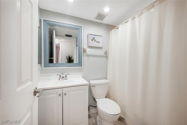 bathroom with curtained shower, vanity, and toilet