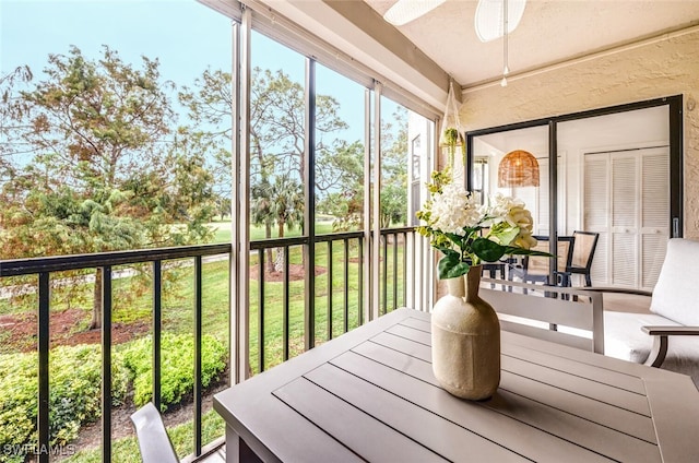 sunroom featuring ceiling fan