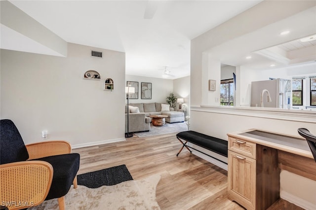 living area featuring ceiling fan and light wood-type flooring