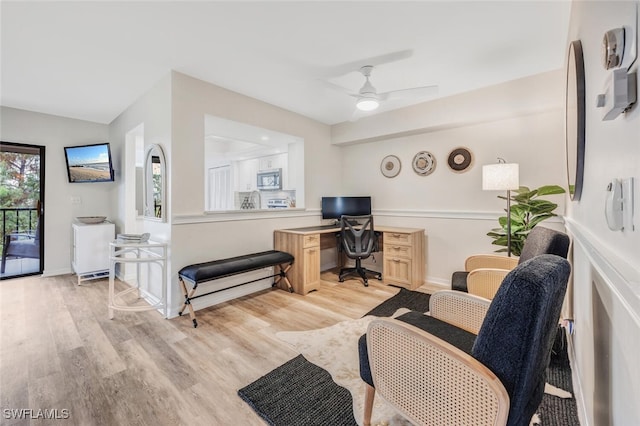 home office featuring ceiling fan and light hardwood / wood-style flooring