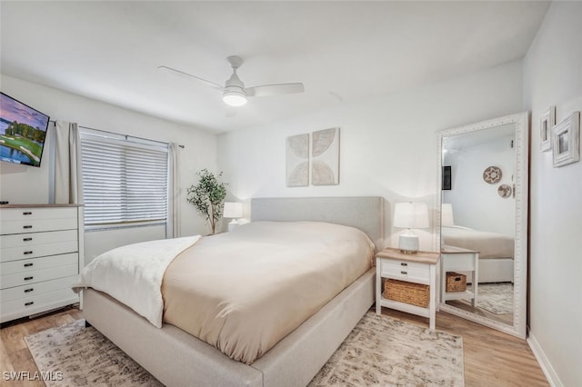 bedroom with light hardwood / wood-style floors and ceiling fan