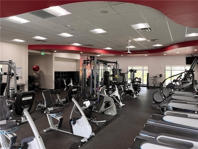 gym with a paneled ceiling