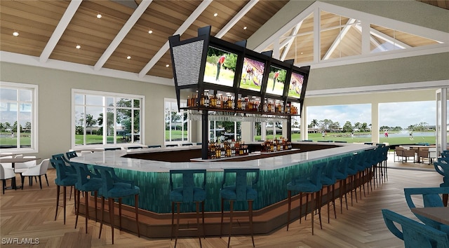 bar featuring wooden ceiling, beamed ceiling, light parquet floors, and high vaulted ceiling