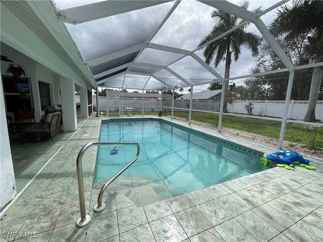 view of swimming pool featuring a patio area and glass enclosure