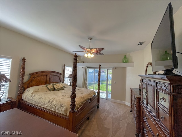 bedroom with multiple windows, access to outside, light colored carpet, and ceiling fan