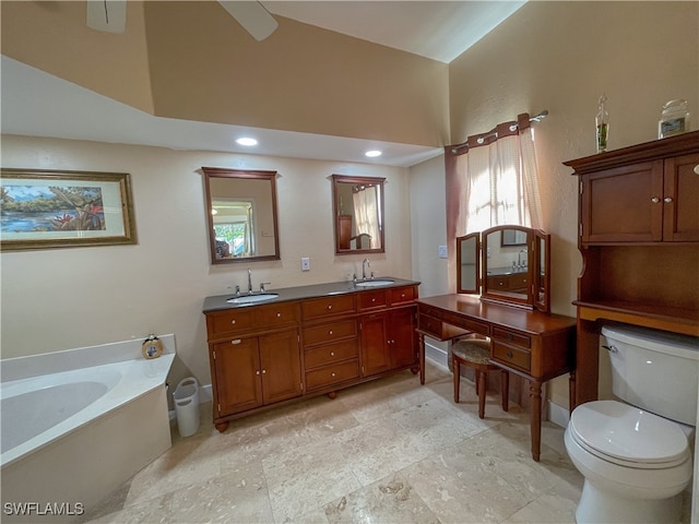 bathroom with a bathing tub, vanity, and toilet