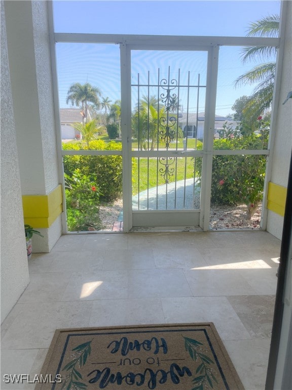 doorway to outside featuring a healthy amount of sunlight