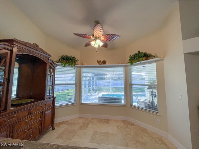 unfurnished dining area featuring ceiling fan