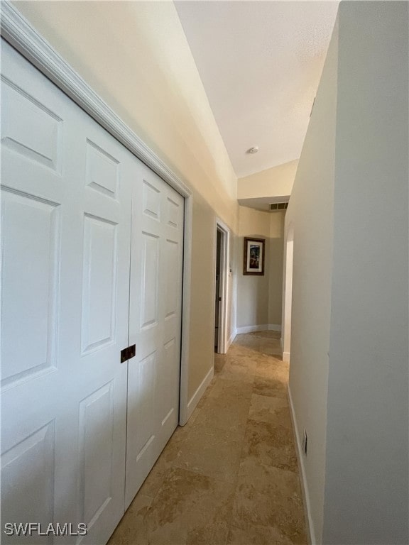 hallway with vaulted ceiling