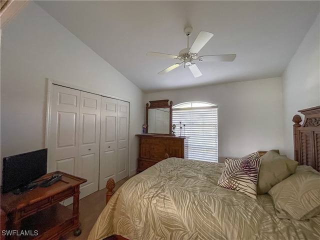 bedroom with lofted ceiling, a closet, and ceiling fan