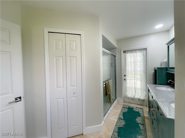 bathroom with vanity and a shower with shower door