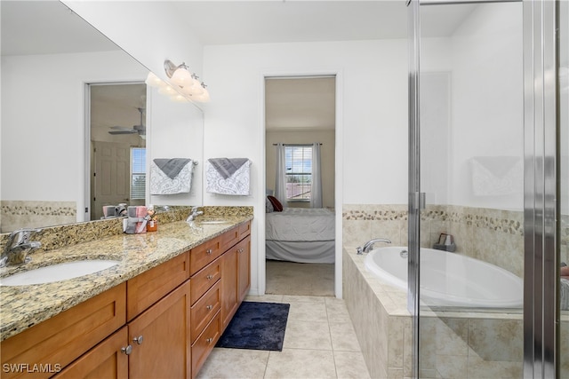 bathroom with vanity, tiled bath, tile patterned floors, and ceiling fan