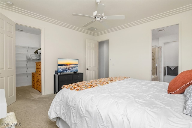 carpeted bedroom with ceiling fan, crown molding, a closet, and a spacious closet