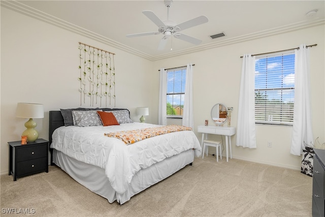 bedroom with ornamental molding, carpet, and ceiling fan