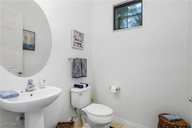 bathroom featuring tile patterned floors, toilet, and sink