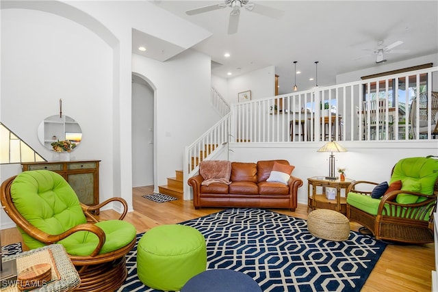 living room with hardwood / wood-style flooring and ceiling fan