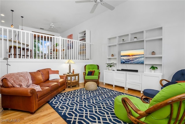 living room with ceiling fan and light hardwood / wood-style floors