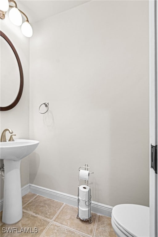 bathroom featuring tile patterned flooring and toilet