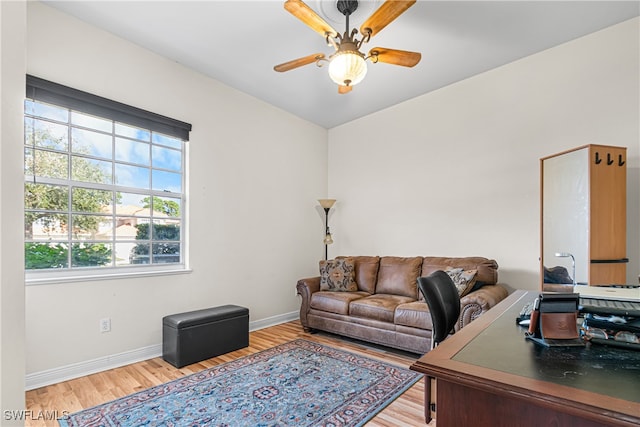 living room featuring hardwood / wood-style flooring and ceiling fan