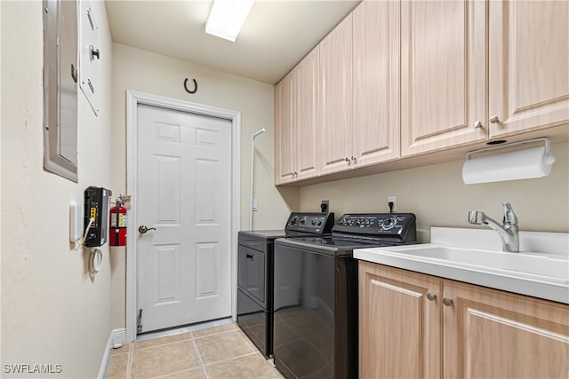 washroom featuring light tile patterned flooring, cabinets, sink, and washing machine and clothes dryer