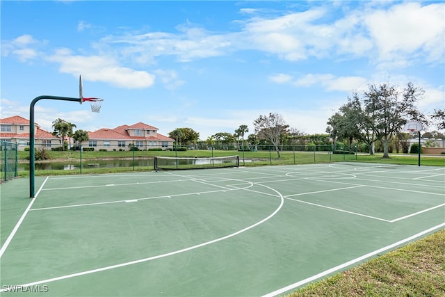 view of basketball court featuring a water view