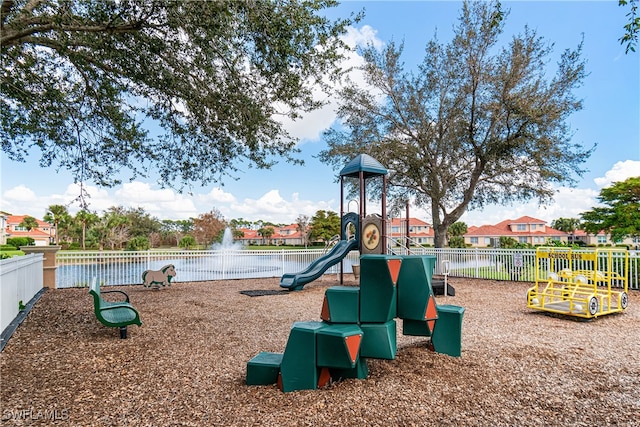 view of jungle gym with a water view