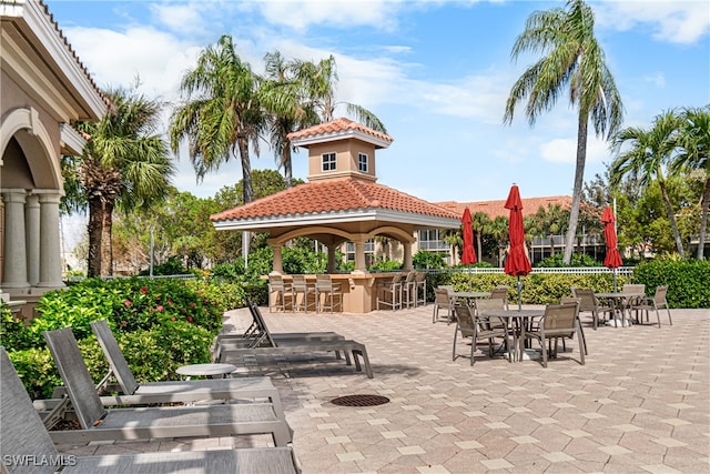 view of community with a bar, a patio, and a gazebo