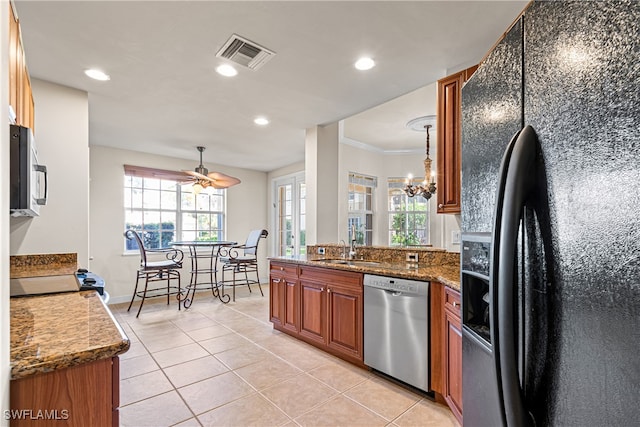 kitchen with black appliances, light tile patterned flooring, crown molding, decorative light fixtures, and sink