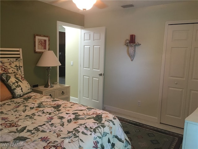 bedroom with ceiling fan and a closet