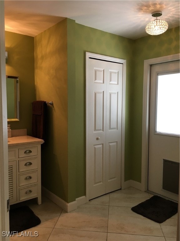 bathroom featuring tile patterned flooring and vanity