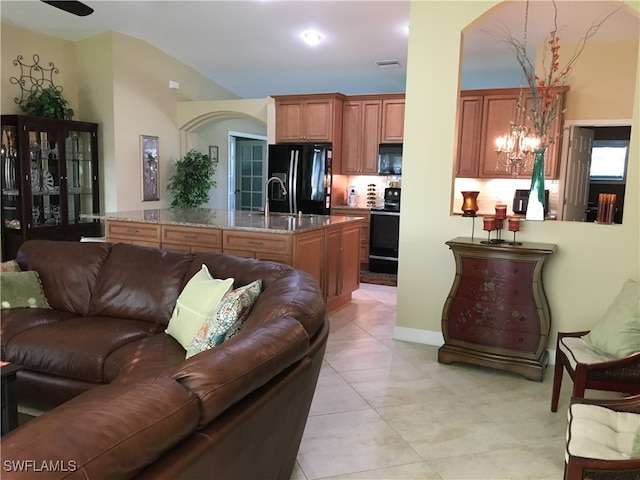 living room with a chandelier and sink