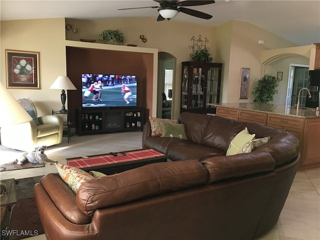 living room with light tile patterned flooring, sink, vaulted ceiling, and ceiling fan