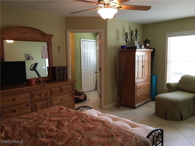 bedroom with ceiling fan and light tile patterned floors