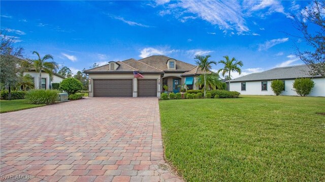 7788 Winding Cypress Dr, Naples, FL 34114 - french provincial home featuring a front yard, decorative driveway, central AC, an attached garage, and stucco siding