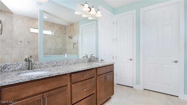 bathroom featuring vanity and a shower with door