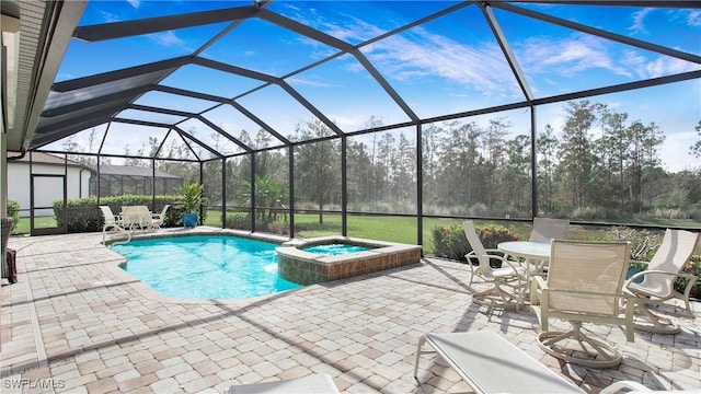 view of pool featuring a lanai, a patio area, and an in ground hot tub