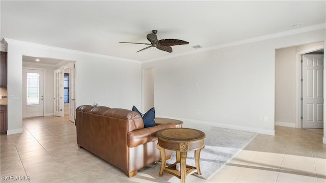 tiled living room with ceiling fan and ornamental molding