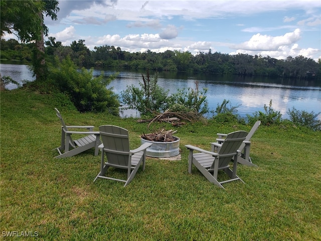 view of yard with a water view and a fire pit