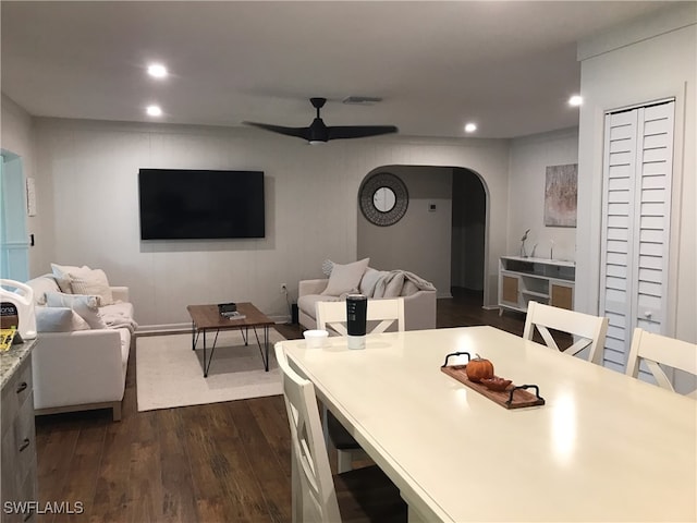 dining room with ceiling fan and dark hardwood / wood-style floors