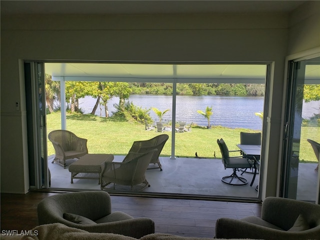 sunroom / solarium featuring a water view