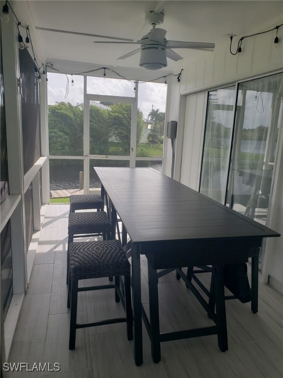 sunroom featuring ceiling fan