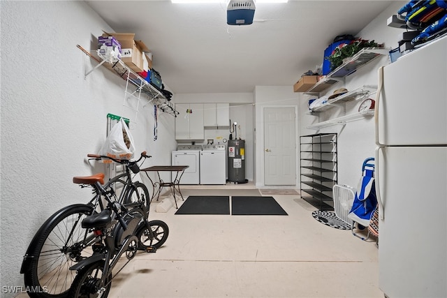 garage featuring washing machine and clothes dryer, electric water heater, and white fridge